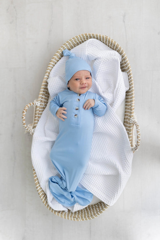 A newborn gown knotted at the bottom.